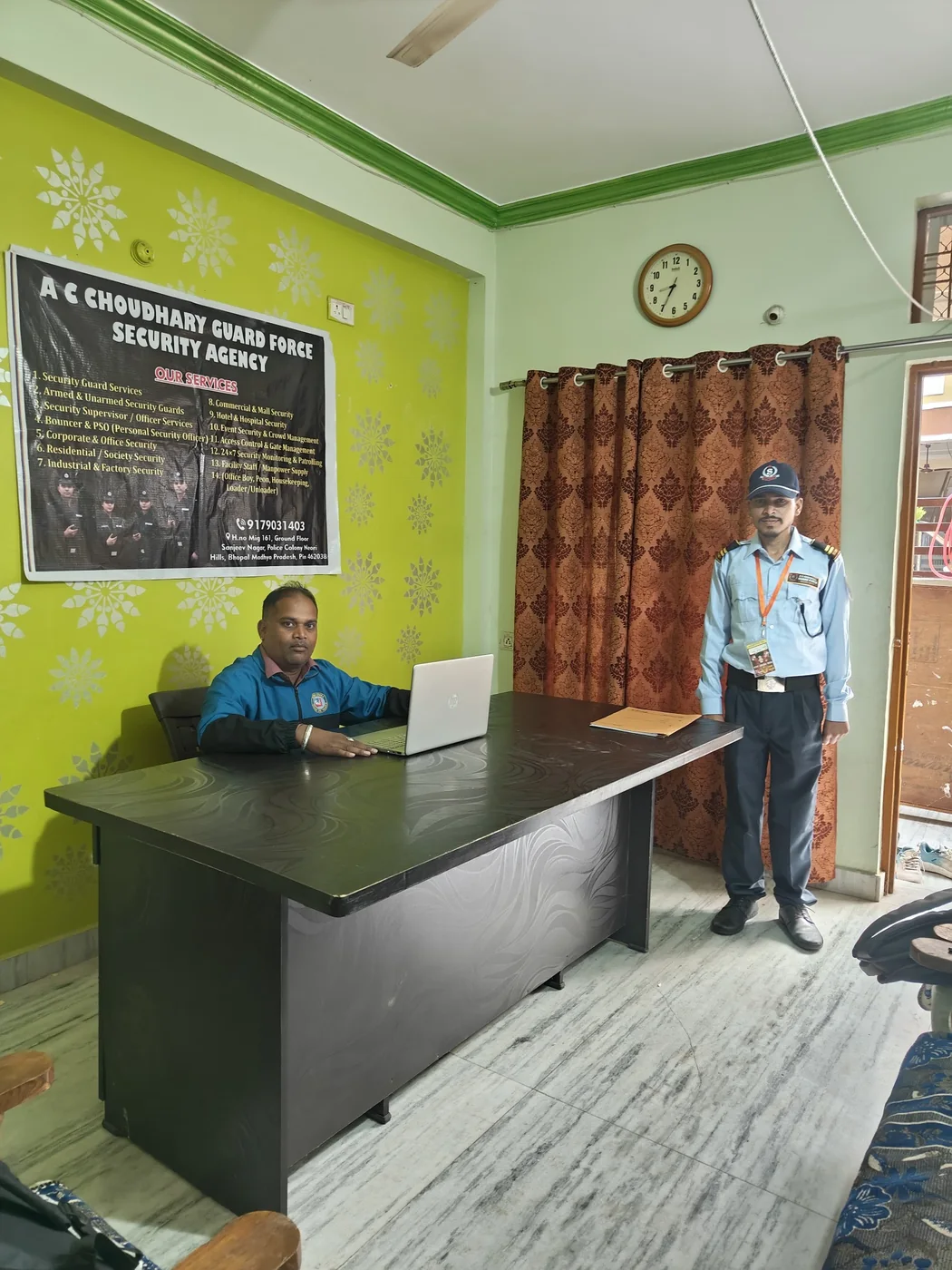 Agency office team and uniformed security guard